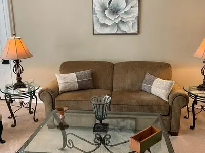 a living room with a couch and two tables at Extended Stays by Lee House Inn in Maysville