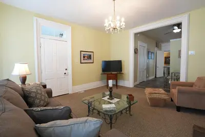 a living room with a couch and a tv at Extended Stays by Lee House Inn in Maysville