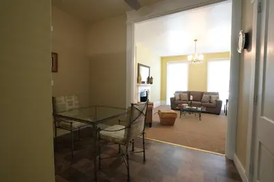 a living room with a glass table and chairs at Extended Stays by Lee House Inn in Maysville