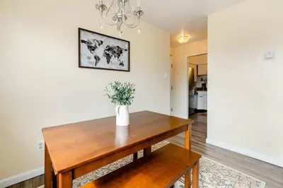 a dining room with a wooden table with a vase on it at Georgetown Villas Nice Valley 3-4c & Creek Views! in Fairview Park