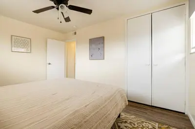 a bedroom with a bed and a ceiling fan at Georgetown Villas Nice Valley 3-4c & Creek Views! in Fairview Park