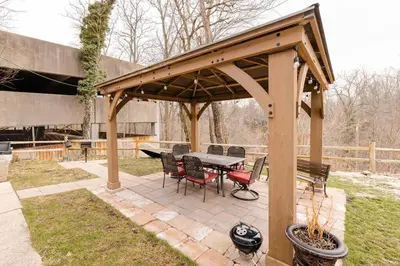 a wooden gazebo with a table and chairs at Georgetown Villas Nice Valley 3-4c & Creek Views! in Fairview Park