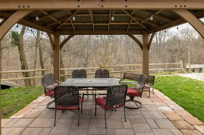 a patio with a table and chairs under a pavilion at Georgetown Villas Nice Valley 3-4c & Creek Views! in Fairview Park