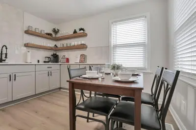 a kitchen with a wooden table and chairs at Housepitality - The OSU Hideaway - 4 BR 5 min from OSU Grandview in Columbus