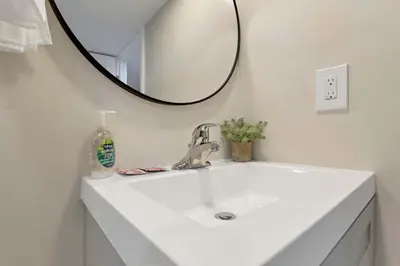 a bathroom with a sink with a mirror and a sink at Housepitality - The OSU Hideaway - 4 BR 5 min from OSU Grandview in Columbus