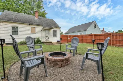 three chairs sitting around a fire pit in a yard at Housepitality - The OSU Hideaway - 4 BR 5 min from OSU Grandview in Columbus
