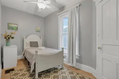 a white bedroom with a bed and a window at Housepitality - Harrison Mansion - Great Location in Columbus