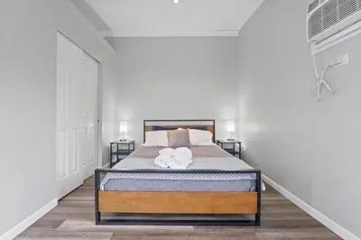 a bedroom with a bed with two towels on it at Housepitality - The Restful Studio - Cozy in Newark