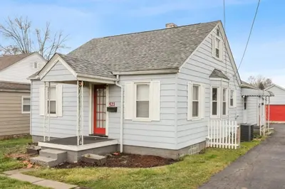 a white house with a red door at Housepitality - The Restful Studio - Cozy in Newark