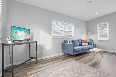 a living room with a blue couch and a table at Housepitality - The Restful Studio - Cozy in Newark