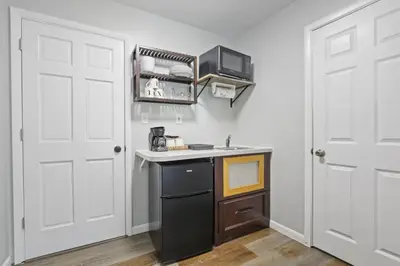 a small kitchen with a sink and a stove at Housepitality - The Restful Studio - Cozy in Newark
