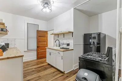 a kitchen with white walls and a stove top oven at Housepitality - The City Gateway in Columbus
