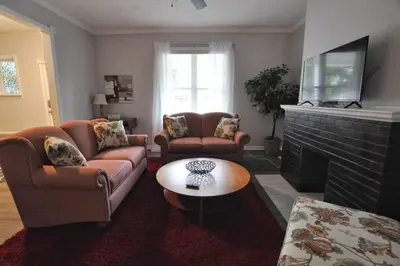 a living room with two couches and a fireplace at Housepitality - Franklinton Manor - Spacious in Columbus