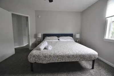 a bedroom with a bed with two pillows on it at Housepitality - Franklinton Manor - Spacious in Columbus