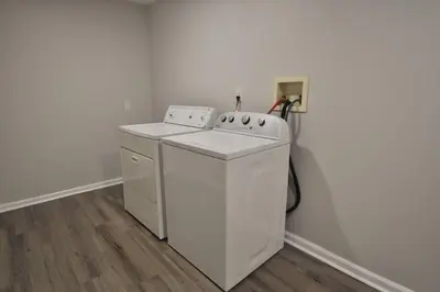 a white washer and dryer in a room at Housepitality - Franklinton Manor - Spacious in Columbus