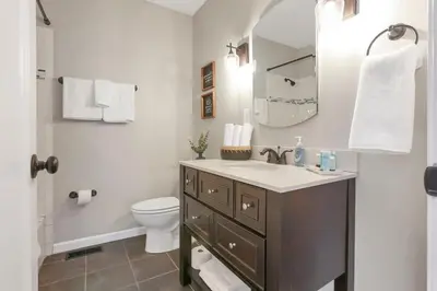 a bathroom with a sink and a toilet and a mirror at Housepitality - The Southwestern in Columbus