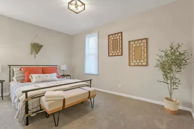 a bedroom with a bed and a potted plant at Housepitality - The Southwestern in Columbus