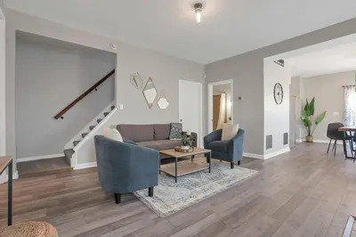 a living room with a couch and a table at Housepitality - The Southwestern in Columbus