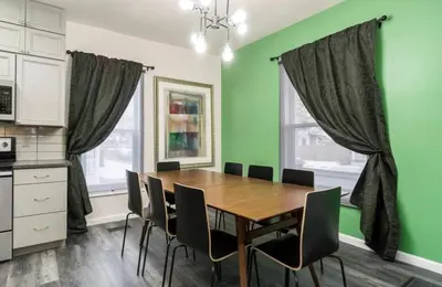 a dining room with a wooden table and chairs at Housepitality - The Mint Julep House in Columbus