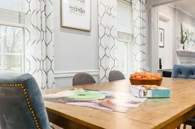 a dining room table with a bowl of oranges on it at Bexley Family Friendly, Staycation, King Bed in Columbus