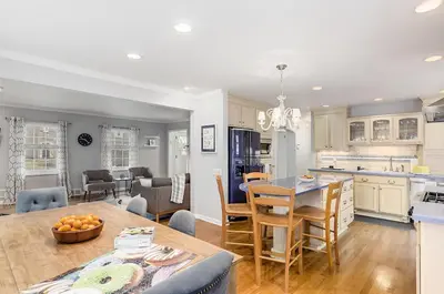 a kitchen and living room with a table and chairs at Bexley Family Friendly, Staycation, King Bed in Columbus