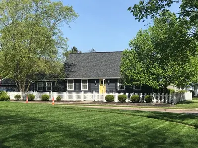 a house with a white fence and a yard at Bexley Family Friendly, Staycation, King Bed in Columbus