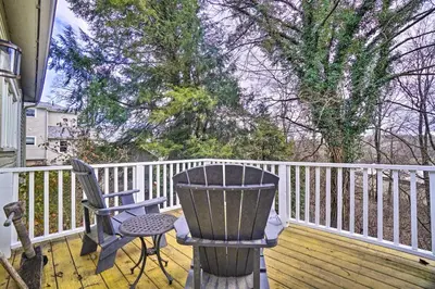 a porch with two chairs and a chair on a deck at The Porch House Located in Historic Village in Granville