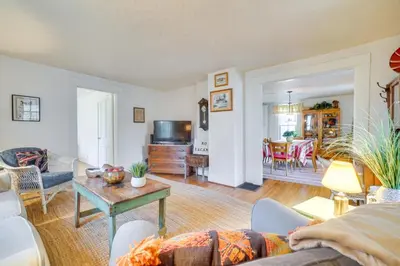 a living room with a couch and a table at The Porch House Located in Historic Village in Granville