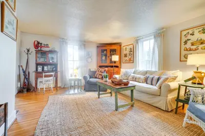 a living room with a couch and a table at The Porch House Located in Historic Village in Granville