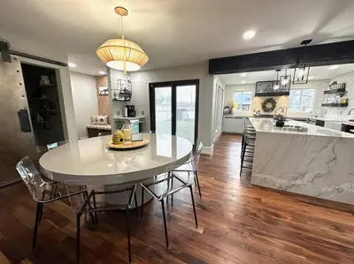 a dining room and kitchen with a table and chairs at Cheerful 4 bedroom home w/ fireplace & game room in Mason