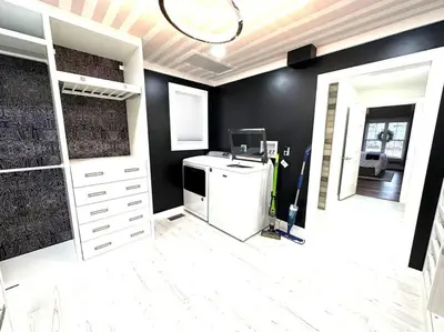 a laundry room with a washer and dryer at Cheerful 4 bedroom home w/ fireplace & game room in Mason