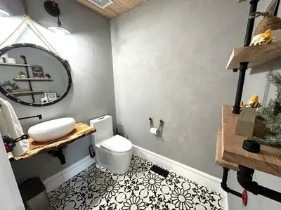 a bathroom with a white toilet and a mirror at Cheerful 4 bedroom home w/ fireplace & game room in Mason