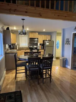 a kitchen with a table and chairs and a dining room at Lakehouse Hot Tub & Pool close to Ark Encounter in Corinth