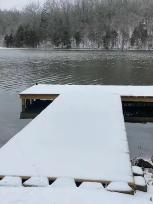a dock in the water with snow on it at Lakehouse Hot Tub & Pool close to Ark Encounter in Corinth