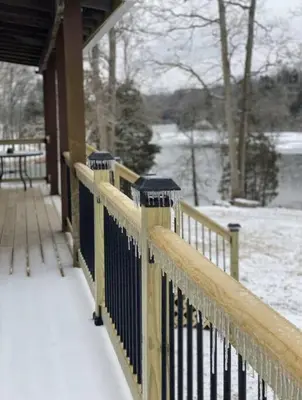 a wooden fence covered in snow next to a building at Lakehouse Hot Tub & Pool close to Ark Encounter in Corinth
