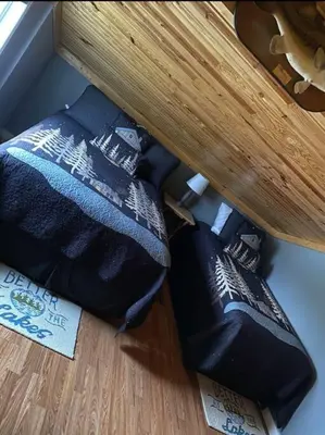 two bags sitting on the floor under a table at Lakehouse Hot Tub & Pool close to Ark Encounter in Corinth