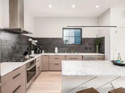 a kitchen with a white counter top and a sink at Historic German Village Industrial Masterpiece in Columbus