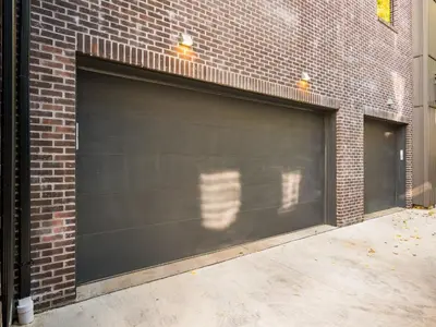 a black garage door on a brick building at Historic German Village Industrial Masterpiece in Columbus