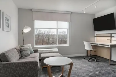 a living room with a couch and a table at TownePlace Suites by Marriott New Philadelphia in New Philadelphia