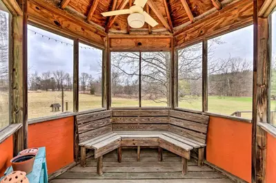 a screened in porch with benches and windows at Natures Haven Farmhouse in Pickerington with Deck in Pickerington