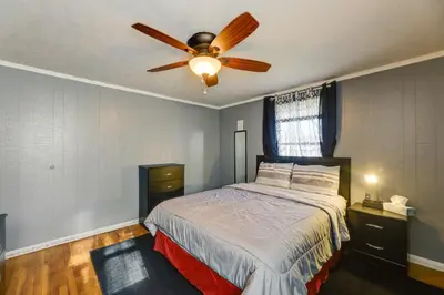 a bedroom with a bed with a ceiling fan at 4-Bedroom Cincinnati Vacation Rental! in Cincinnati