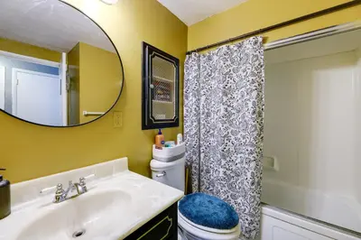 a bathroom with a sink and a mirror and a toilet at 4-Bedroom Cincinnati Vacation Rental! in Cincinnati