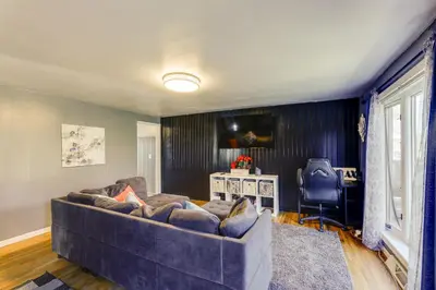 a living room with a large couch and a desk at 4-Bedroom Cincinnati Vacation Rental! in Cincinnati