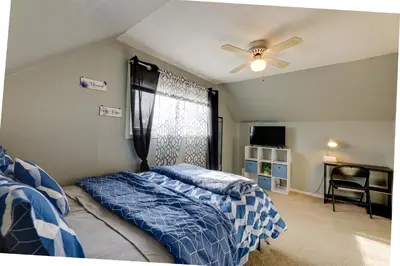 a bedroom with a bed and a ceiling fan at 4-Bedroom Cincinnati Vacation Rental! in Cincinnati