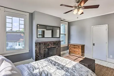 a bedroom with a fireplace and a ceiling fan at NEW Grand Historic Home - 4 Mi to WEC! in Wilmington