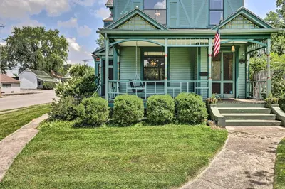 a blue house with a flag on a street at NEW Grand Historic Home - 4 Mi to WEC! in Wilmington