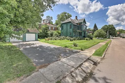 a green house on the side of a street at NEW Grand Historic Home - 4 Mi to WEC! in Wilmington