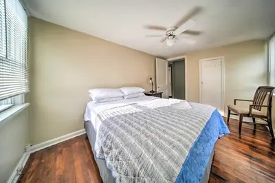 a bedroom with a bed and a ceiling fan at Eastlake Home with Patio Less Than 1 Mi to Lake Erie! in Eastlake