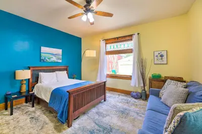 a bedroom with a bed and a couch at Cincinnati Home with Deck and Private Hot Tub! in Cincinnati