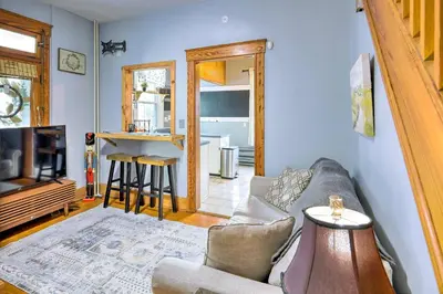 a living room with a couch and a tv at Cincinnati Home with Deck and Private Hot Tub! in Cincinnati